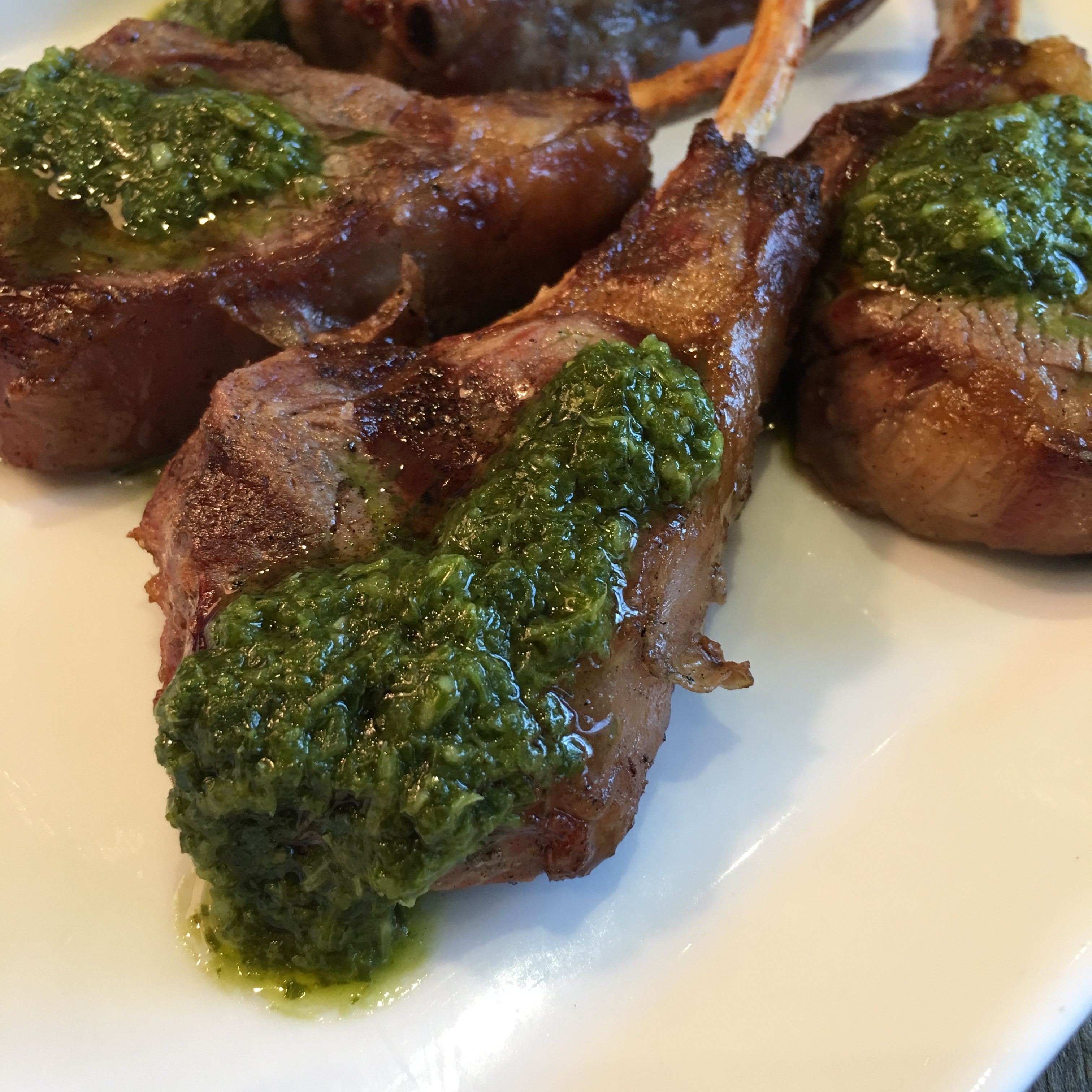 lamb racks with chimichurri sauce dripping down