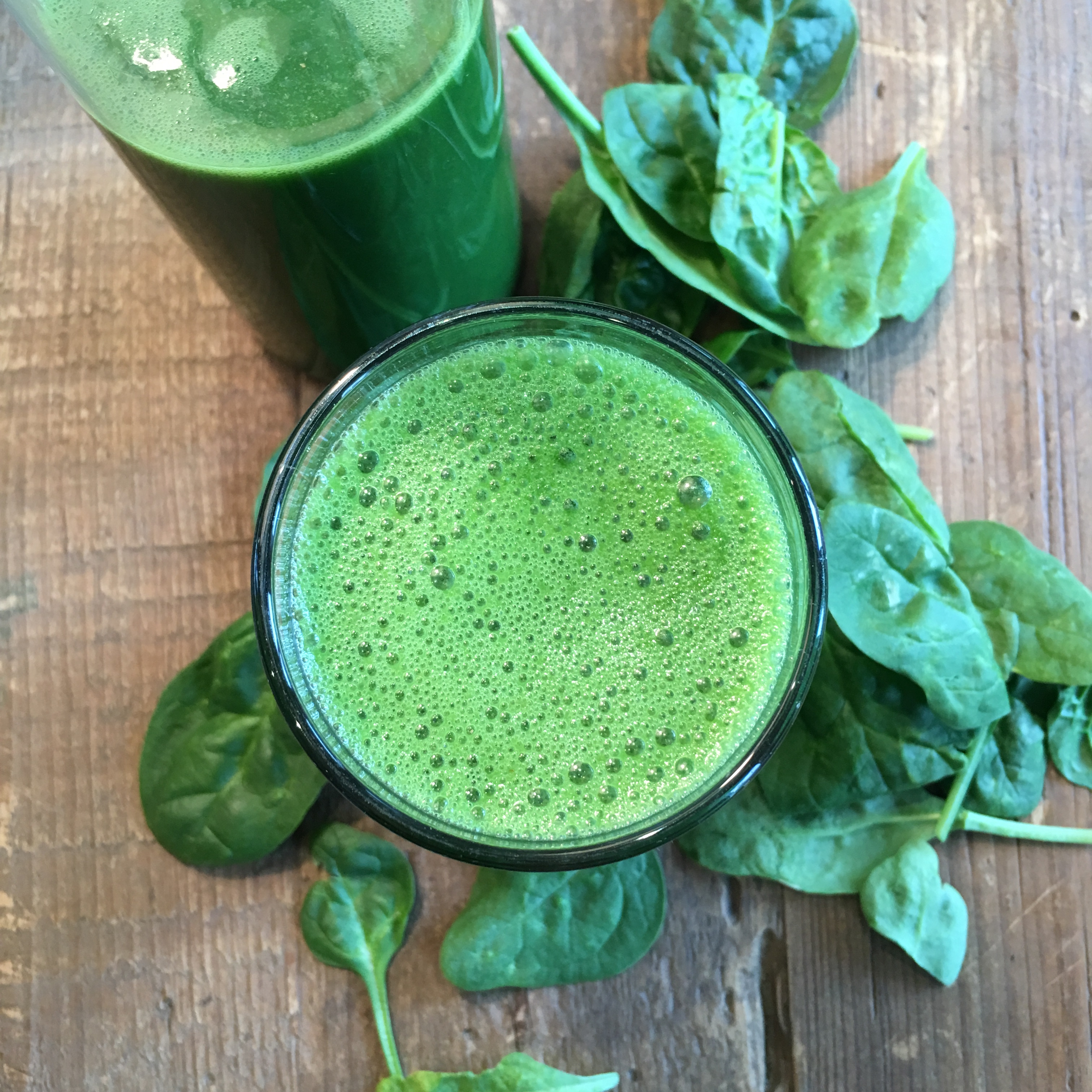 Turns out, Mom was right. But, you already knew that eating green vegetables seriously improves your health. The more I study nutrition, the more I realize that no matter how many green veggies you eat, you still probably aren’t getting enough. So don’t just eat your greens…DRINK your greens in the form of this healthy smoothie! Life gets hectic so it’s not always easy to eat healthy. The key is organization and planning. At the beginning of each week I buy and wash a bunch of smoothie ingredients so they are ready to go. That way, it’s faster to throw them in the blender when you are rushing out the door. OR, if you know your morning is tight, put the majority of fruits and veggies in the container the night before so the next morning all you have to do is add your liquid and ice cubes and press ‘start’. Voila, done in about three minutes! I like to make enough for two servings. I drink one at breakfast and save one for a mid-morning snack. A healthy smoothie is THE simplest way to start your day on the right foot and it makes sticking with a clean eating plan SO much easier. I want to provide my body with great nutrients and my gut with enough fibre so my whole digestive system will work optimally. You can play with lots of different green combinations. I’ve done a fair bit of experimenting and I find these core ingredients work well together: Celery: Rich in vitamin K, A and C and also contains folate and potassium. It mainly consists of water, but it’s a great source of dietary fibre which is SO important. Spinach: A source of magnesium, folate, vitamins B2, B6, A and K. Spinach (along with parsley, kale and chard) has anti-oxidant and anti-cancer properties and improves your eyesight, skin and hair. Ginger: Helps with digestion and inflammation. Lemon: Not just a great source of vitamin C, B6, A and E but it is THE key to making your greens more palatable and gives it a thinner consistency. Although lemon is very acidic in taste, when the juice has been fully metabolized, its effect is said to be alkalizing. That’s great since so much of what we North Americans eat is very acidic. 
